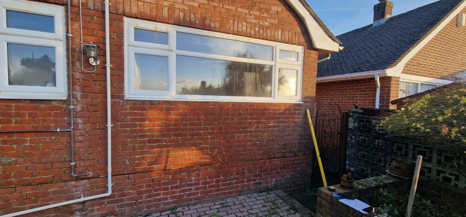 Before: an old window in the back wall of a bungalow