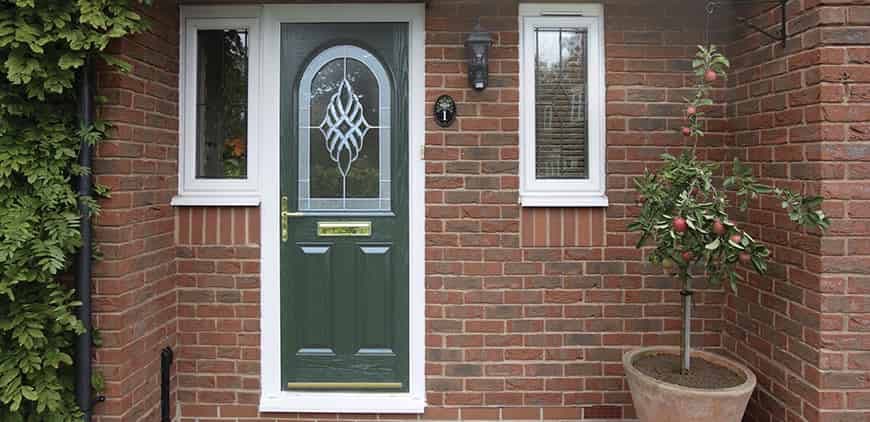 Green composite front door with decorative glass and matching side windows