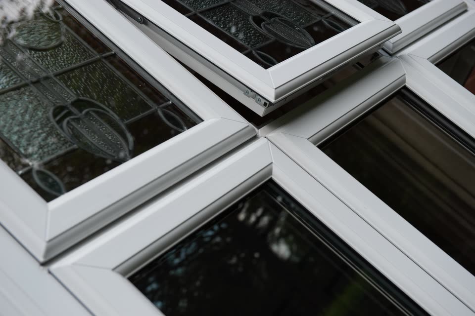 Close-up of white uPVC window sashes with decorative leaded glass