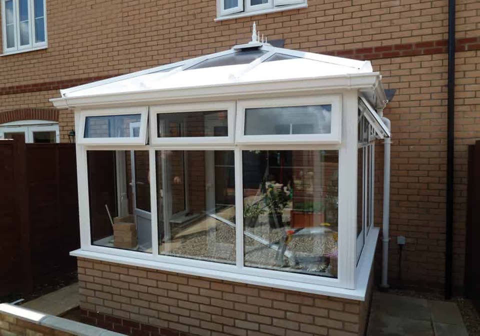 Small white uPVC conservatory with a glazed roof