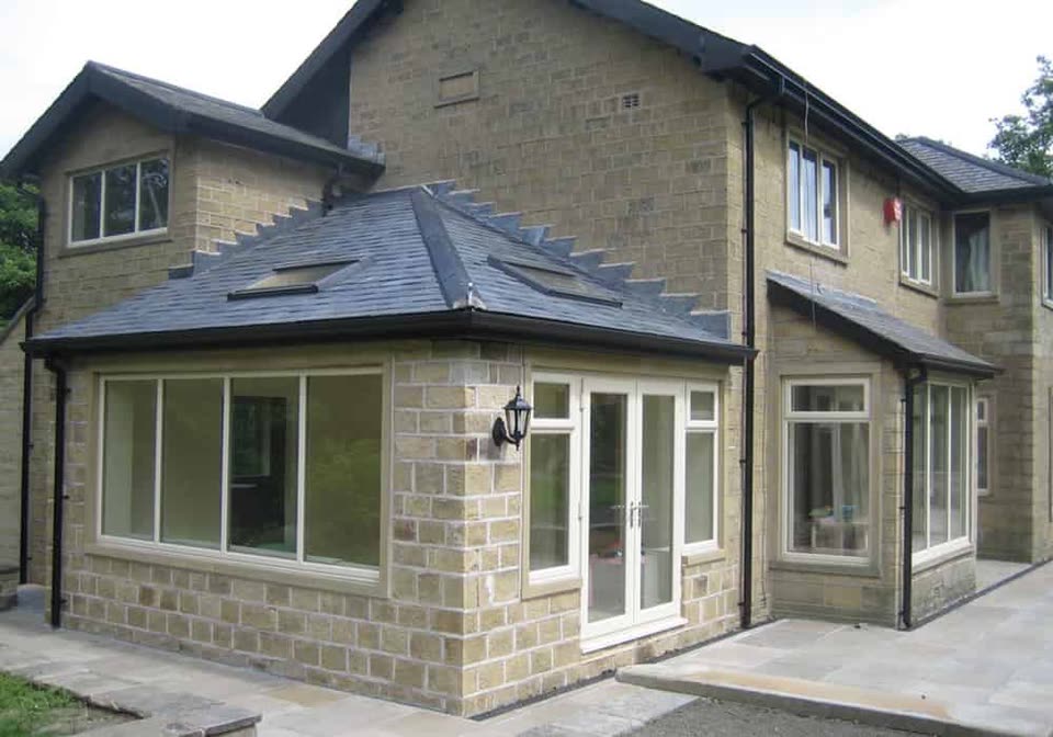 Stone extension with white uPVC windows and French doors
