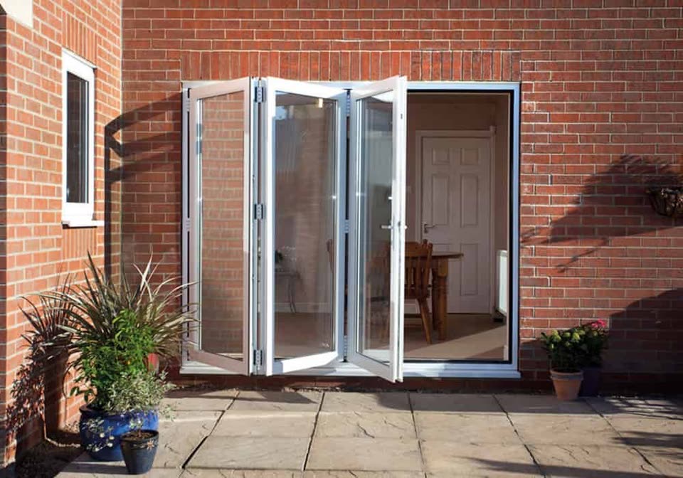 White bi-fold doors folded open onto a patio