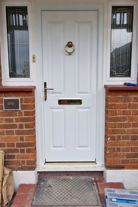 White front door with glazed side panels and top lights