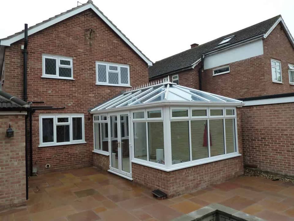 White uPVC conservatory on the back of a brick house